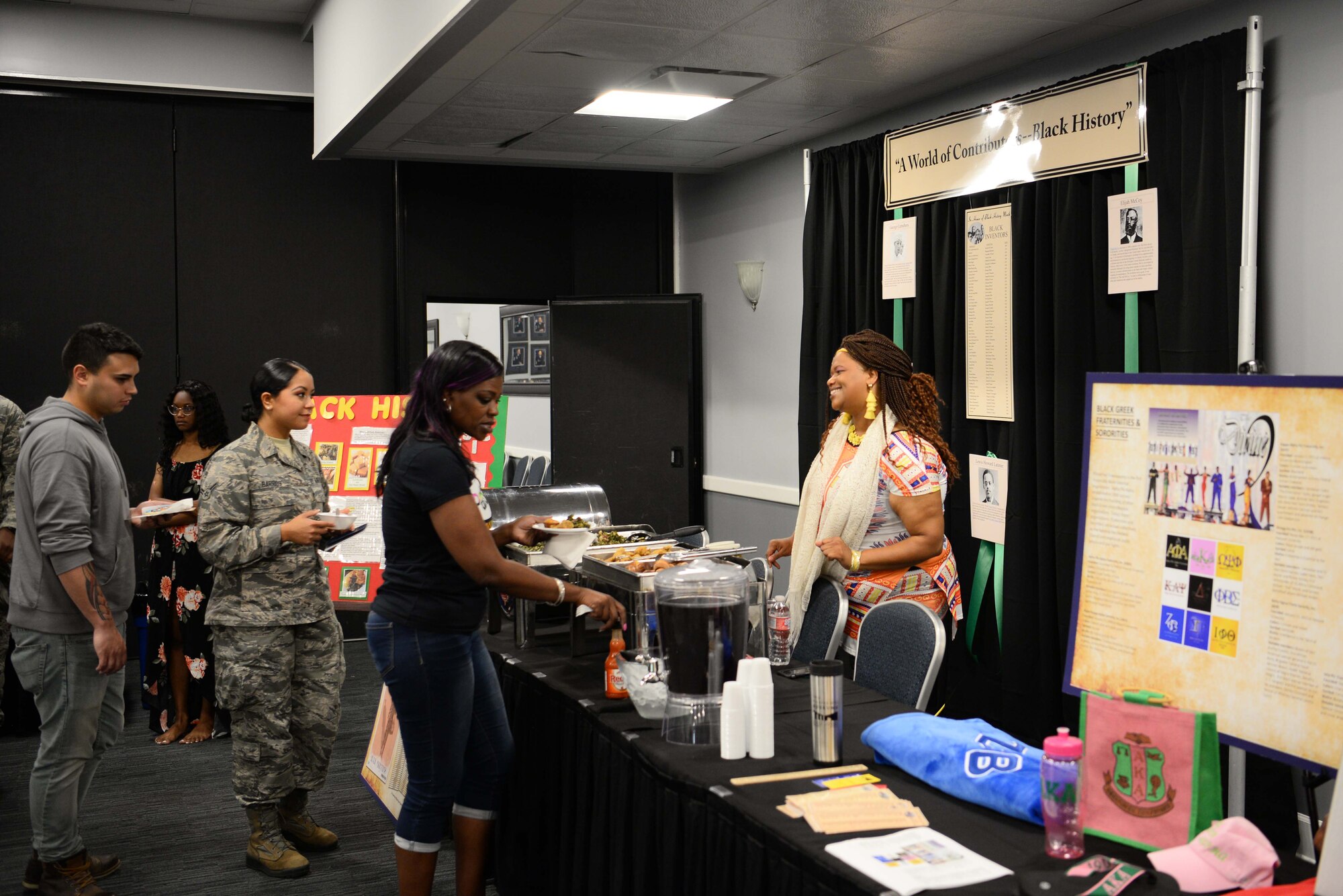 Individuals in line to get food at the black history booth, June 7, 2019, on Columbus Air Force Base, Miss. The event featured multiple special observances booths for Airmen and their families to learn about the different cultures. (U.S. Air Force photo by Airman 1st Class Jake Jacobsen)