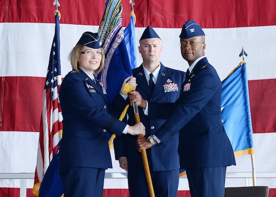 U.S. Air Force Maj. Gen. May O'Brien, 25th Air Force commander, passes the 55th Wing guidon to Col. Gavin Marks,  during the 55th Wing Change of Command ceremony June 14, 2019, inisde Dock 1 of the Bennie Davis Maintenance Facility at Offutt Air Force Base, Nebraska. Marks assumed command from Col. Michael H. Manion, who departs Offutt AFB for the Pentagon.
