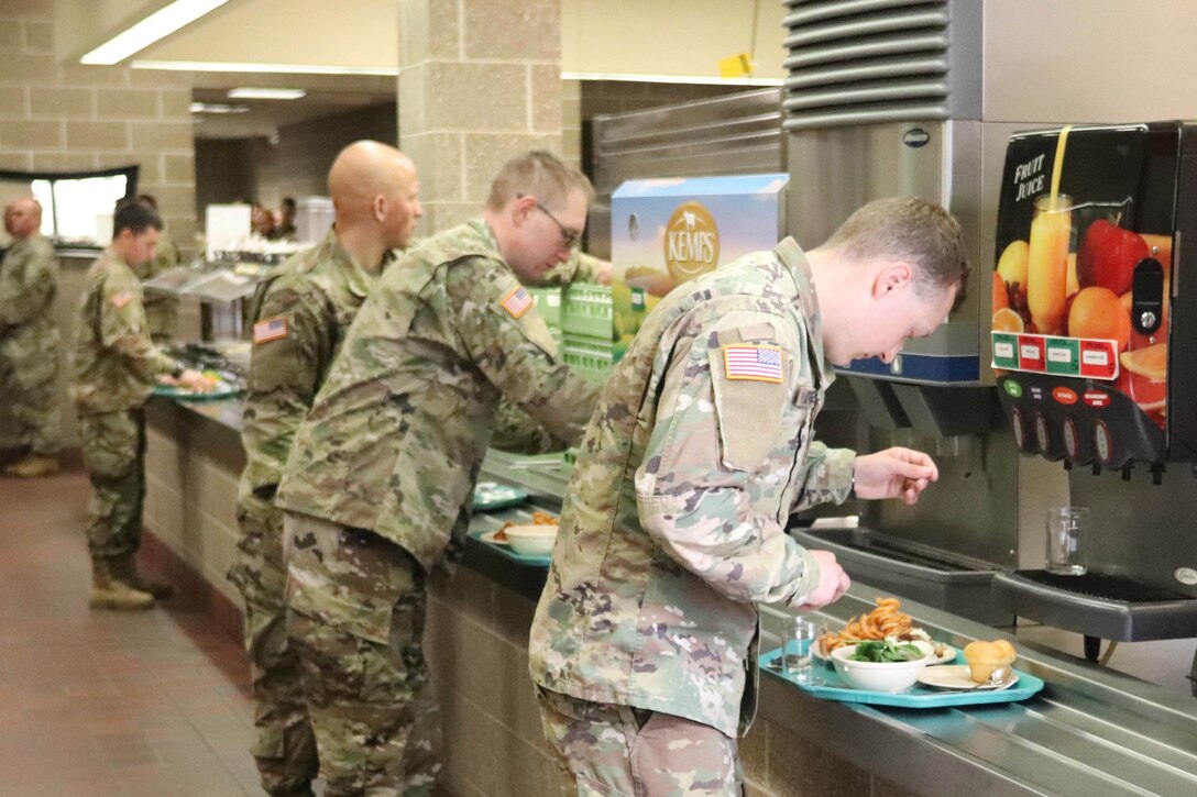 Troops line up to get food.