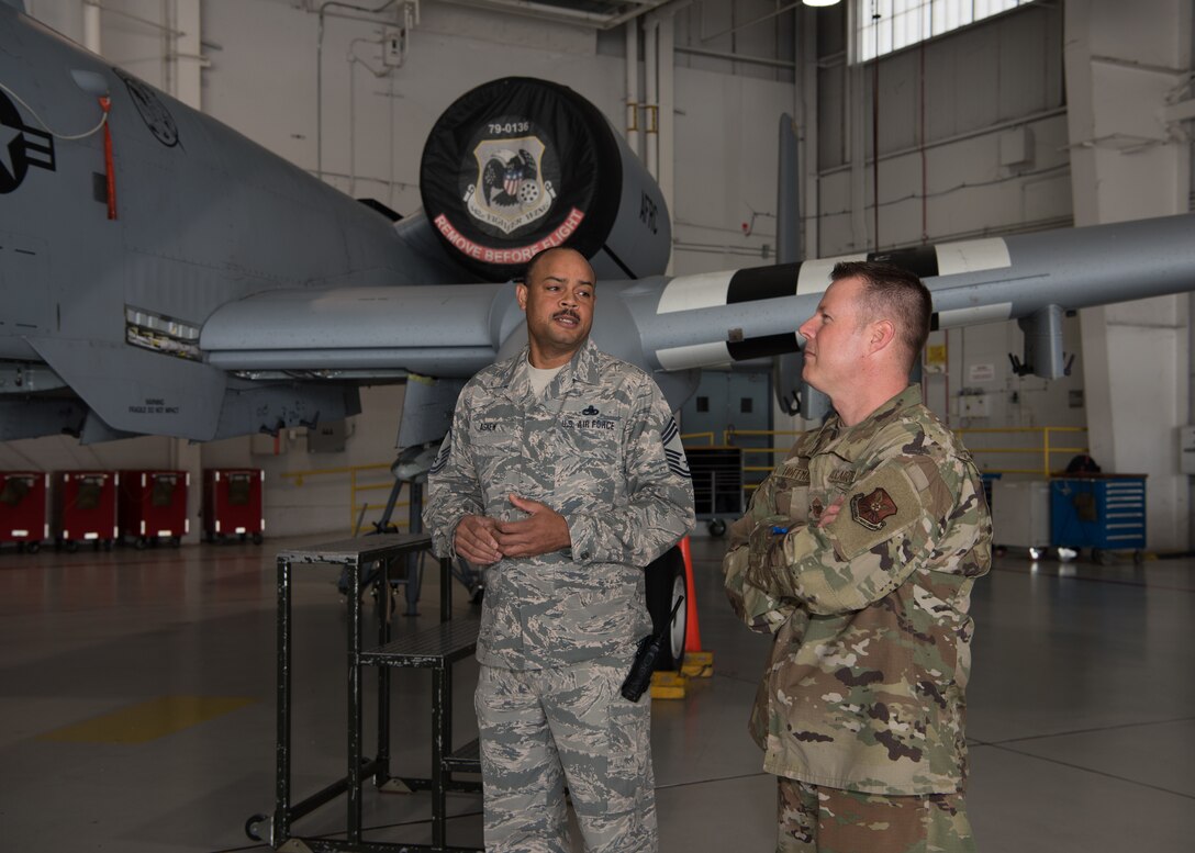 Chief Master Sgt. Kellie Askew, the superintendent of the 442nd Aircraft Maintenance Squadron explains the role of the 442nd AMXS and the A-10 to Chief Master Sgt. Charles R. Hoffman, the command chief of Air Force Global Strike Command from Barksdale Air Force Base, Louisiana, on June 11, 2019 at Whiteman Air Force Base, Missouri. While visiting the 442nd AMXS, Hoffman had the opportunity to look inside the A-10 and learn from the Airmen who worked on it. (U.S. Air Force Photo by Airman 1st Class Parker J. McCauley)
