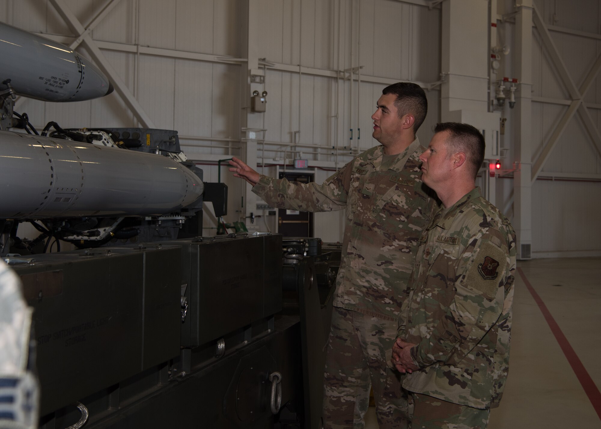 Airman 1st Class Kyle Vaught, a special weapons maintenance team member with the 509th Munitions Squadron talks with Chief Master Sgt. Charles R. Hoffman, the command chief of Air Force Global Strike Command from Barksdale Air Force Base, Louisiana, on June 11, 2019, at Whiteman Air Force Base, Missouri. Vaught talked about his job and the equipment he commonly works with in munitions along with his role in the mission. (U.S. Air Force Photo by Airman 1st Class Parker J. McCauley)