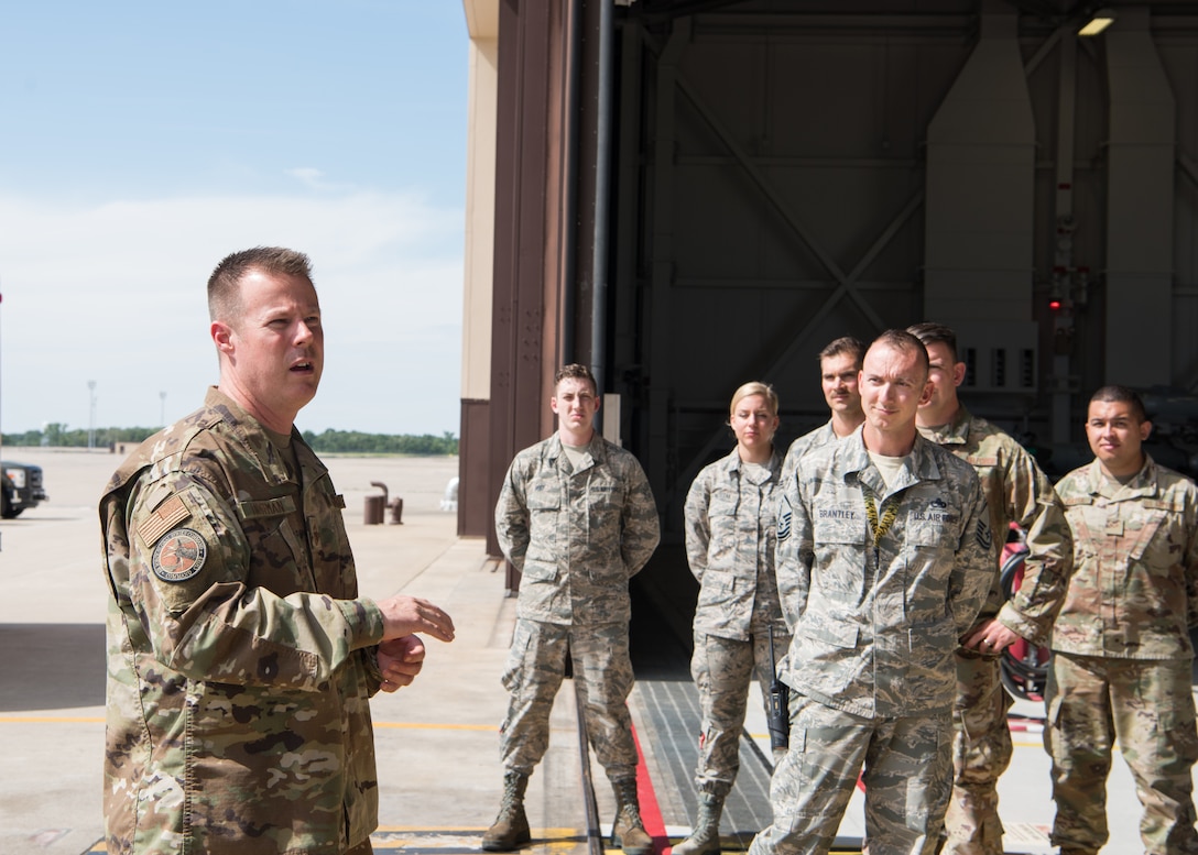 Chief Master Sgt. Charles R. Hoffman, the command chief of Air Force Global Strike Command from Barksdale Air Force Base, Louisiana, speaks to Airmen with the 509th and 131st Bomb Wings after touring a B-2 Spirit on June 11, 2019, at Whiteman Air Force Base, Missouri. The Airman taught him about their roles on base and the jobs that they all do throughout the day during his total immersion tour of the base. (U.S. Air Force Photo by Airman 1st Class Parker J. McCauley)