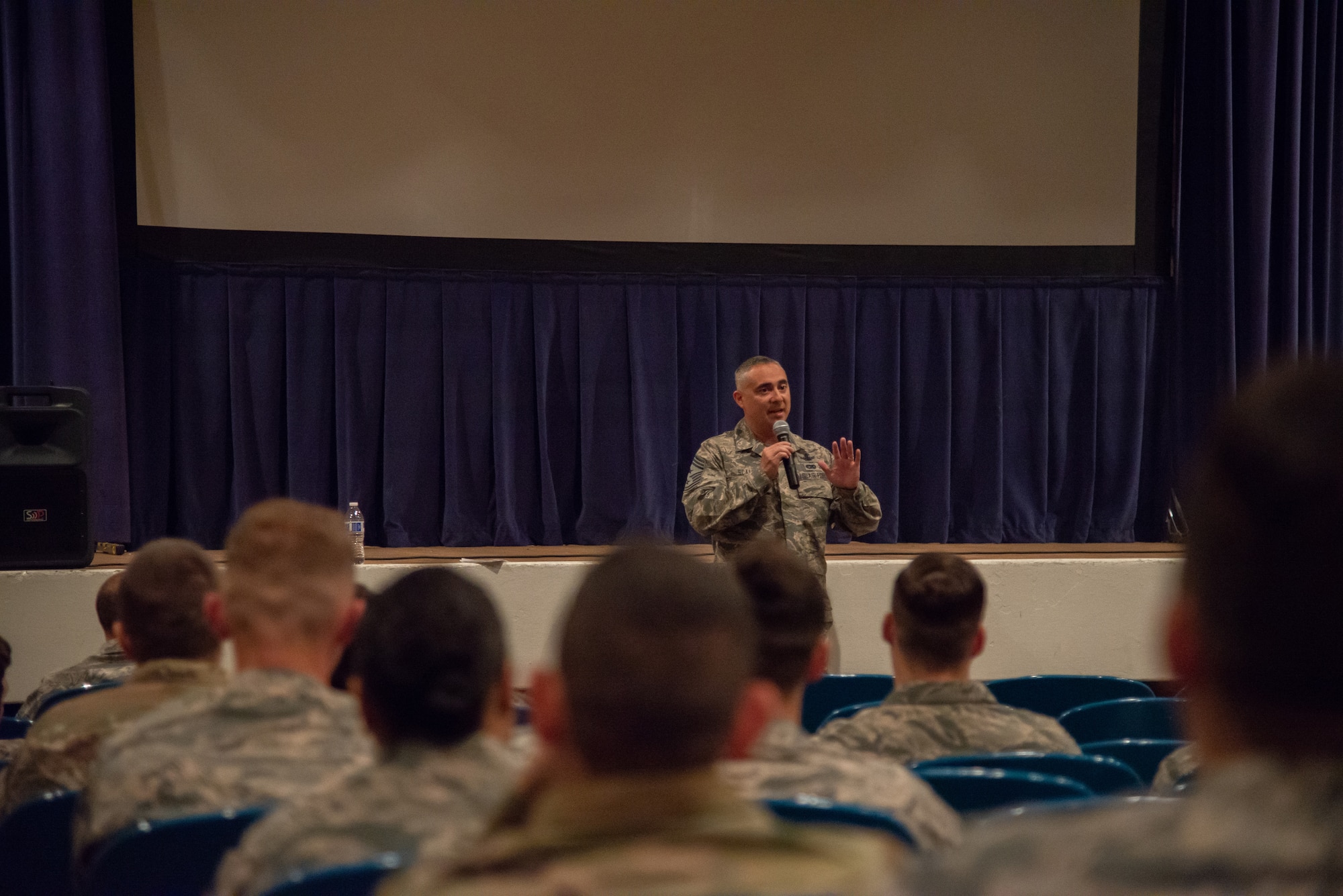 Chief Master Sgt. Kahn Scalise, the 302nd Airlift Wing command chief, addresses junior Reserve Citizen Airmen during an enlisted town hall meeting in the base theater June 1, 2019 at Peterson Air Force Base, Colorado.