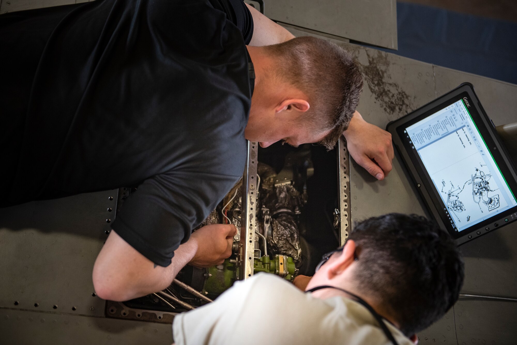 Airman Grantham Dorriety, left, and Airman Gregory Herrera, 364th Training Squadron electrical and environmental systems apprentice course students, remove a backup bleed air valve at Sheppard Air Force Base, Texas, June 14, 2019. The backup bleed air valve controls the air pressure for the air conditioning unit in the flight-deck, without proper air pressure the pilot could pass out. Once the students remove the valve they will learn how to re-install it. (U.S. Air Force photo by Airman 1st Class Pedro Tenorio)