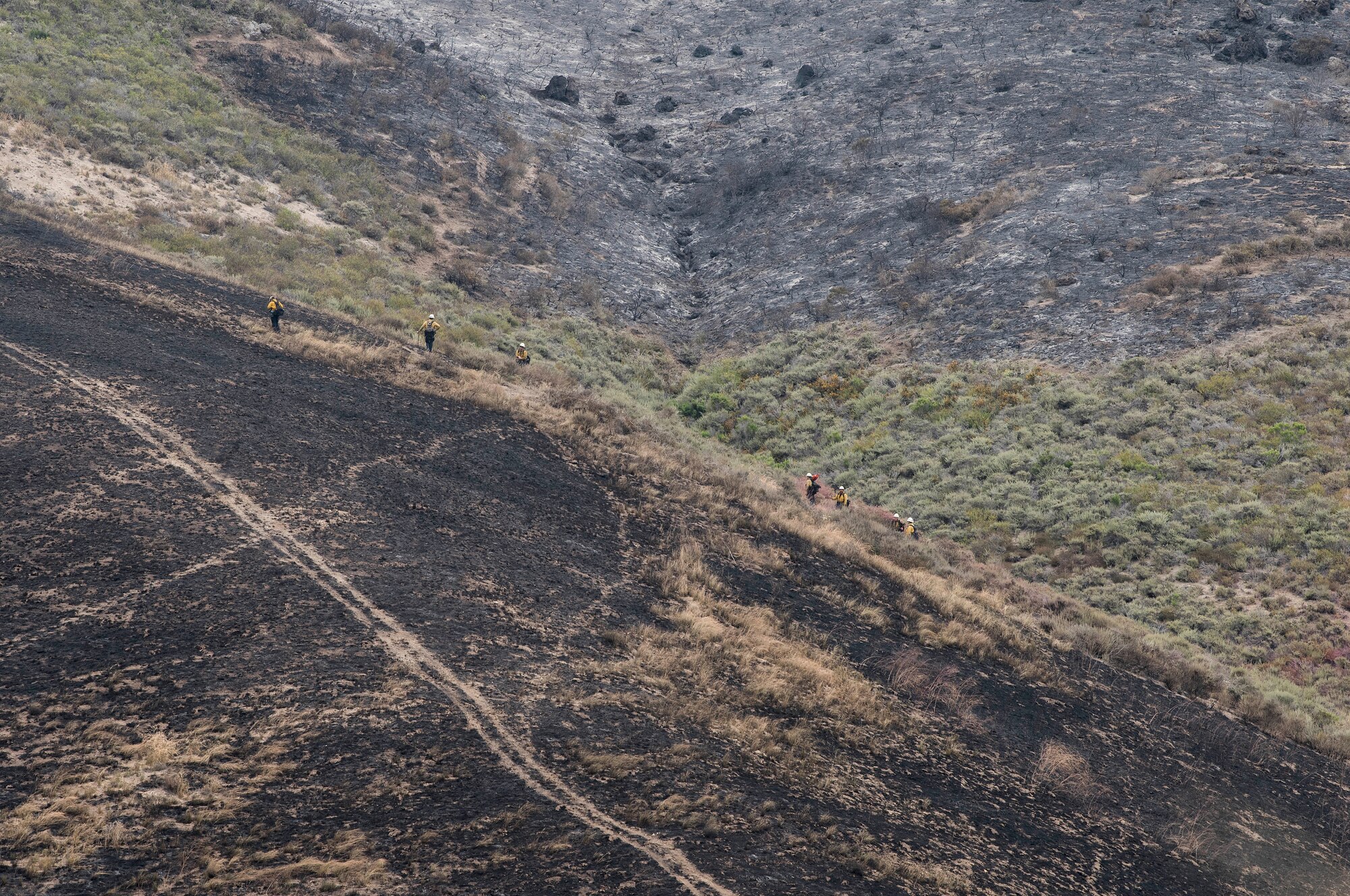 30th Space Wing firefighters work with the Santa Barbara Fire Department to mitigate the Rancho Fire June 14, 2019, at Vandenberg Air Force Base, Calif. The fire burned approximately 140 acres near Point Sal and El Rancho roads. (U.S. Air Force photo by Airman 1st Class Hanah Abercrombie)