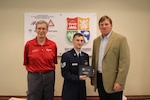 Staff Sgt. Nathan Lindgren, 502 Civil Engineer Squadron firefighter, receives the key to the city from New Braunfels Mayor Pro Tem Wayne Peters, left, and Mayor Barron Casteel during a ceremony on May 14 that honored Lindgren as the New Braunfels Chamber of Commerce Airman of the Quarter.