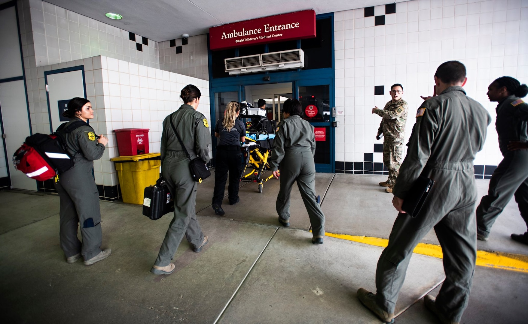 Critical air transport team members from the 59th Medical Wing and local emergency medical technicians walk into the Children’s Medical Center of Dallas to pick up 7-month-old patient, Nakoa Crawford, June 7, 2019. Nakoa’s transfer required a concerted effort between local EMTs, hospital, U.S. Air Force and Navy officials in Dallas, San Antonio and San Diego.