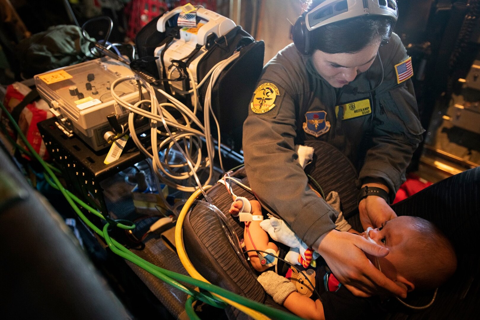 Senior Airman Analiese Heitkamp, 59th Medical Wing critical air transport team respiratory therapist, adjusts 7-month-old patient, Nakoa Crawford’s, hearing protection in flight between Dallas and San Diego, June 7, 2019. Nakoa was born prematurely at 25 weeks and has had significant health issues since. Now stable enough to be moved, he was able to be transported to a hospital closer to home in a mobile intensive care unit.