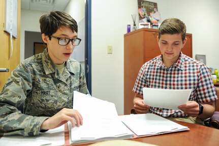 Airman 1st Class Jamie Hart, a contract specialist assigned to the 628th Contracting Squadron, goes over the procedures for reviewing a contract with Aleric Stell, an intern assigned to the 628th CONS, June 13, 2019, at Joint Base Charleston, S.C.