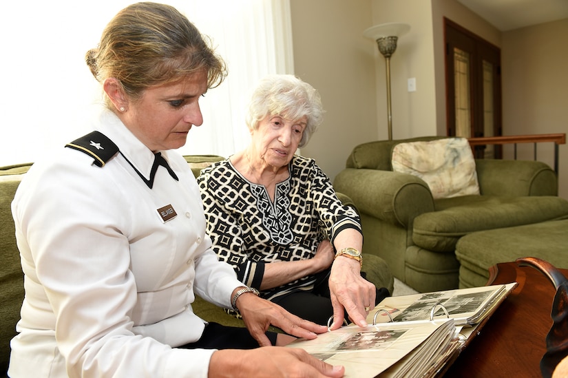 Brig. Gen. Kris A. Belanger, Commanding General, 85th U.S. Army Reserve Support Command looks at a scrapbook compiled by Aida Bonsonto of her husband’s Army service during World War II.
