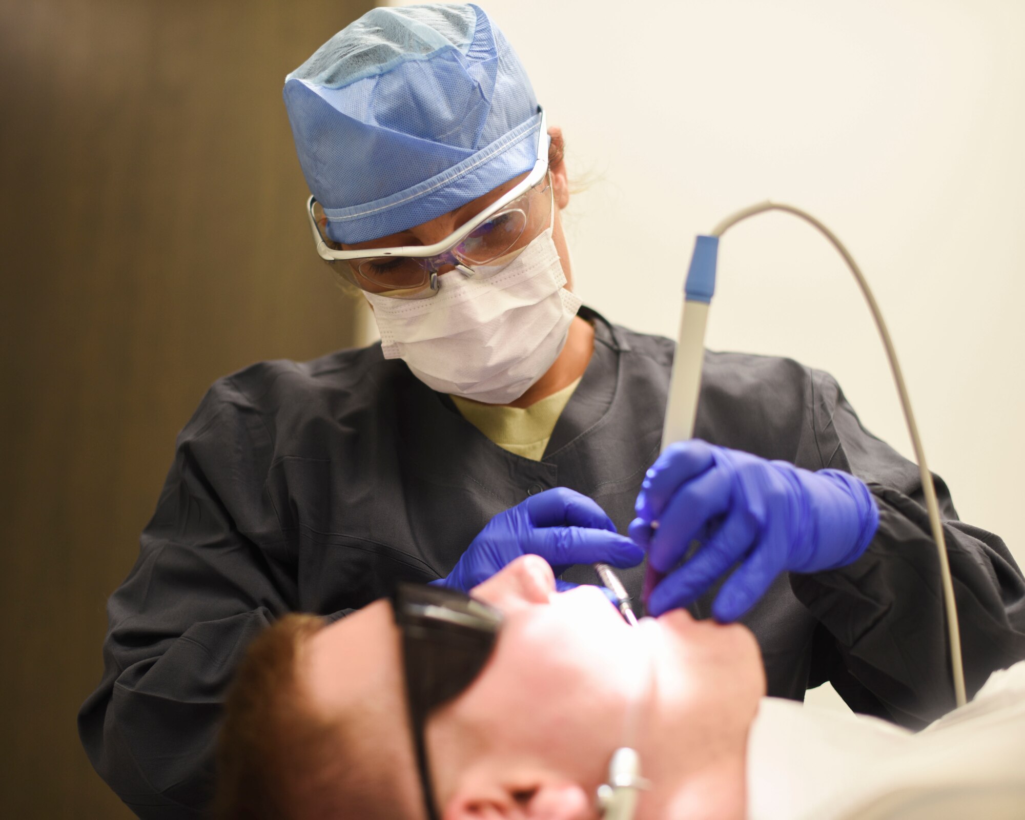 U.S. Air Force Tech. Sgt. Kyrsys Hoffman-Martinez, 325th Medical Group dental flight chief, performs a dental cleaning June 6, 2019, at Tyndall Air Force Base, Florida.