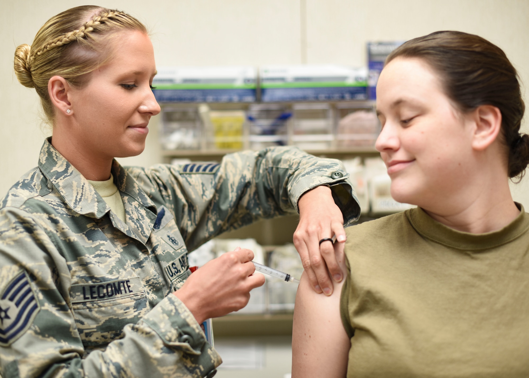 U.S. Air Force Tech. Sgt. Haley Lecomte, 325th Medical Group immunizations noncommissioned officer in charge, administers a vaccine to Staff Sgt. Alyssa Korb, 325th MDG aerospace medical technician, June 6, 2019, at Tyndall Air Force Base, Florida.
