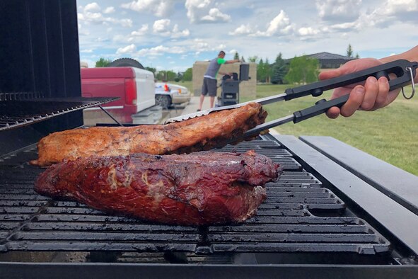 A participant smokes meat during a Wing One Association hosted tri-tip cook-off June 13, 2019, at Malmstrom Air Force Base, Mont.