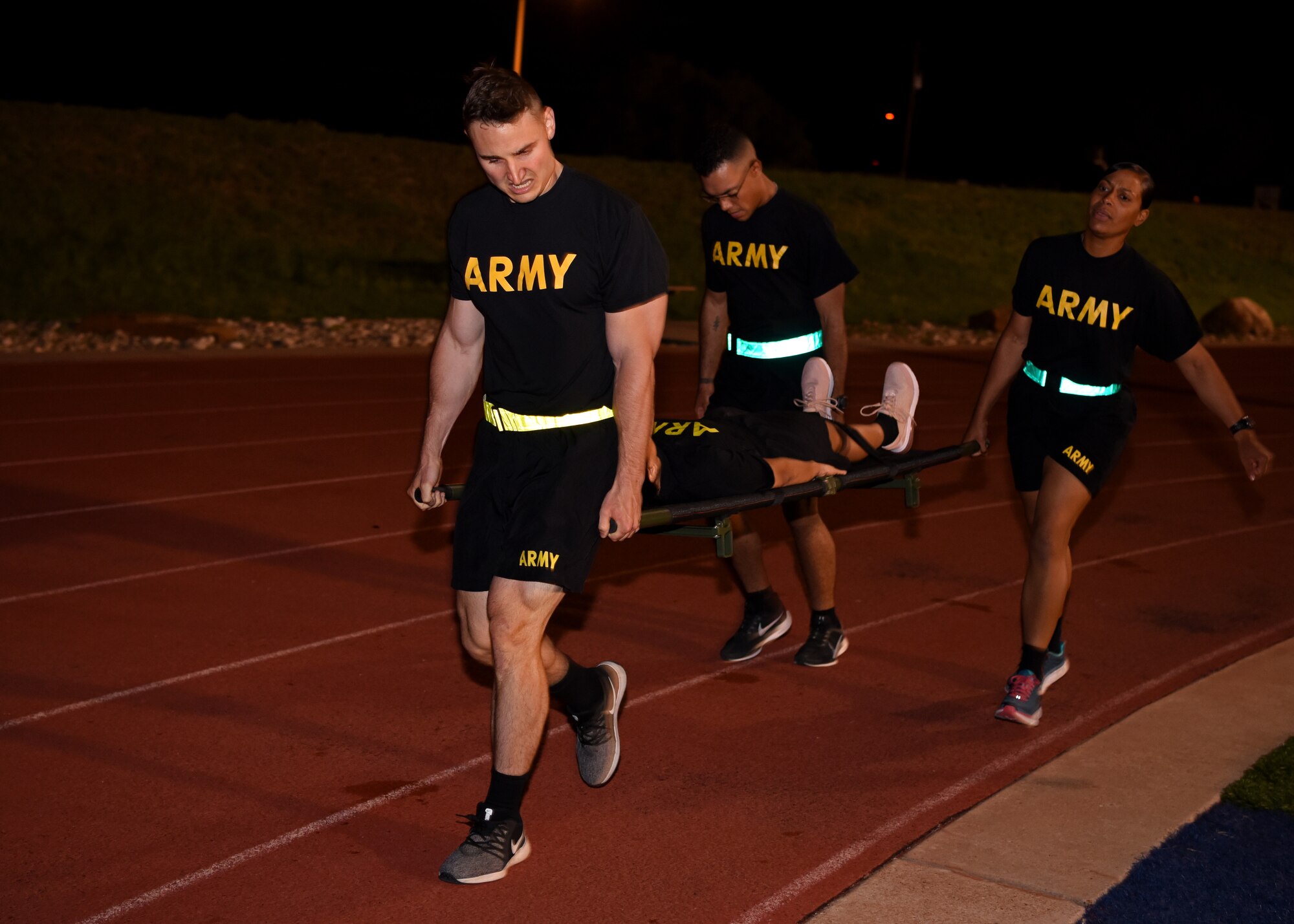 U.S. Army Soldiers run with a soldier on a stretcher as part of the Army’s Birthday PT Challenge at the Mathis Fitness Center on Goodfellow Air Force Base, Texas, June 14, 2019. Each team carried water containers and a person on a stretcher as fast as they could around the track. (U.S. Air Force photo by Airman 1st Class Ethan Sherwood/Released)