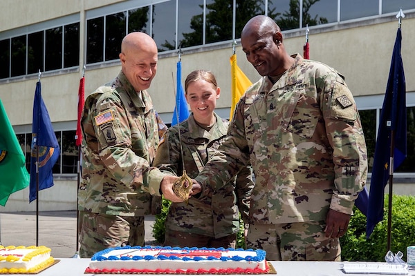 Maj. Gen. David C. Coburn, U.S. Army Financial Management Command commanding general, left; Spc. Kayla Adkins, 384th Military Police Company, center; and Command Sgt. Maj. Courtney Ross, USAFMCOM command sergeant major, cut a birthday cake during a ceremony celebrating both the 244th Army birthday and the 244th birthday of the Army Finance Corps at the Maj. Gen. Emmett J. Bean Federal Center in Indianapolis June 14, 2019. It is an Army tradition that the youngest Soldier available at an Army birthday celebration help the commander and sergeant major cut a cake, and Adkins was the youngest at 22 years old. (U.S. Army photo by Mark R. W. Orders-Woempner)