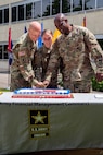 Maj. Gen. David C. Coburn, U.S. Army Financial Management Command commanding general, left; Spc. Kayla Adkins, 384th Military Police Company, center; and Command Sgt. Maj. Courtney Ross, USAFMCOM command sergeant major, cut a birthday cake during a ceremony celebrating both the 244th Army birthday and the 244th birthday of the Army Finance Corps at the Maj. Gen. Emmett J. Bean Federal Center in Indianapolis June 14, 2019. It is an Army tradition that the youngest Soldier available at an Army birthday celebration help the commander and sergeant major cut a cake, and Adkins was the youngest at 22 years old. (U.S. Army photo by Mark R. W. Orders-Woempner)