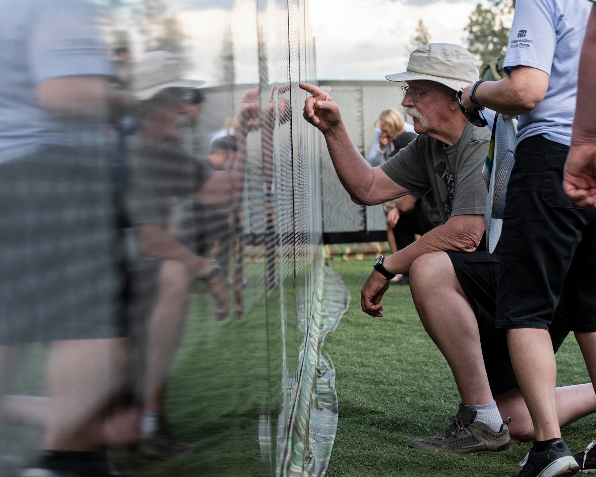 Visitors of “The Moving Wall,” a half-size replica of the Vietnam Memorial that stands in Washington D.C., search for names of loved ones, friends, and comrades lost on the Vietnam War following the opening ceremony of the wall June 13, 2019 in Medical Lake, Wash. Visitors can view the display 24 hours a day at the 200 block of South Prentis St. in Medical Lake. (U.S. Air National Guard photo by Staff Sgt. Rose M. Lust/Released)