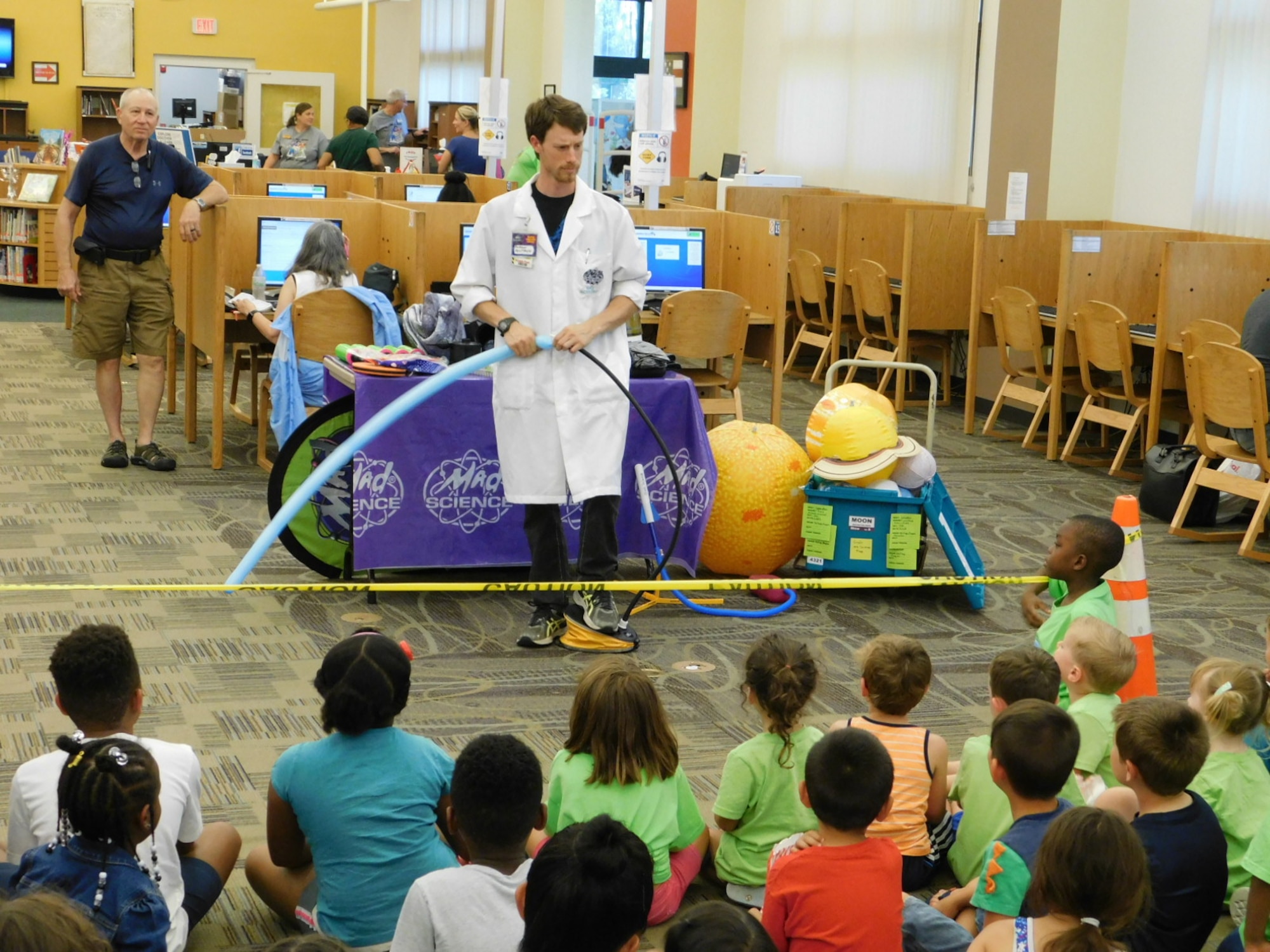 Children listen to a solar system presentation at the Mitchell Memorial Library during the Summer Reading Program kick-off event June 10, 2019, at Travis Air Force Base, California. The program promotes reading and learning across all ages. (U.S. Navy photo by Petty Officer 3rd Class Malcolm Kelley)