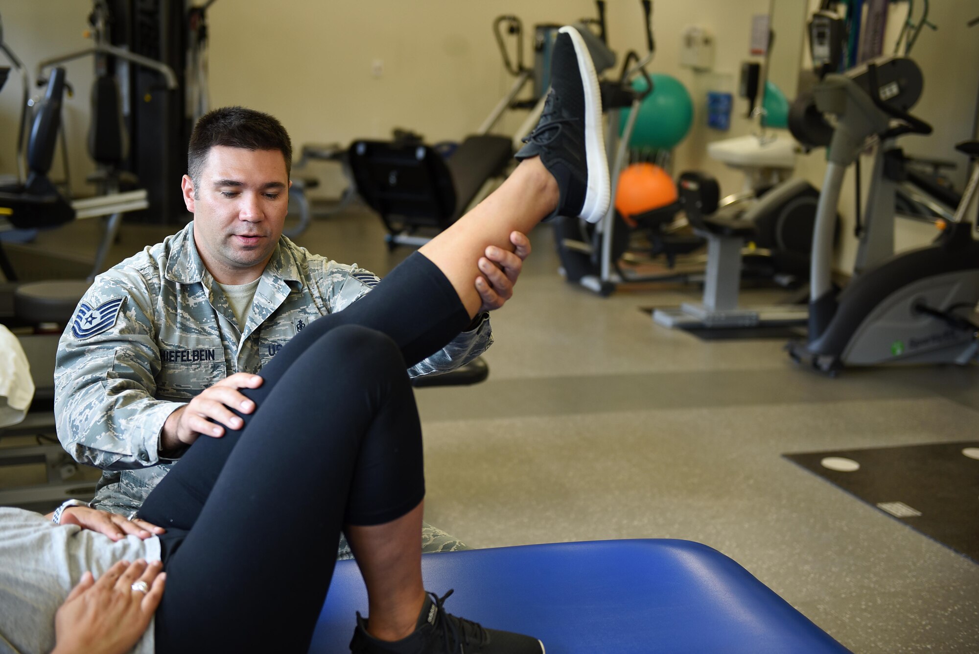 U.S. Air Force Tech. Sgt. Antone Shiefelbein, 14th Medical Operations Squadron clinical medicine flight chief, works with a patient at Columbus Air Force Base, Mississippi, June 11, 2019. The physical therapy team sees more than 2,000 patients annually. (U.S. Air Force photo by Senior Airman Keith Holcomb)