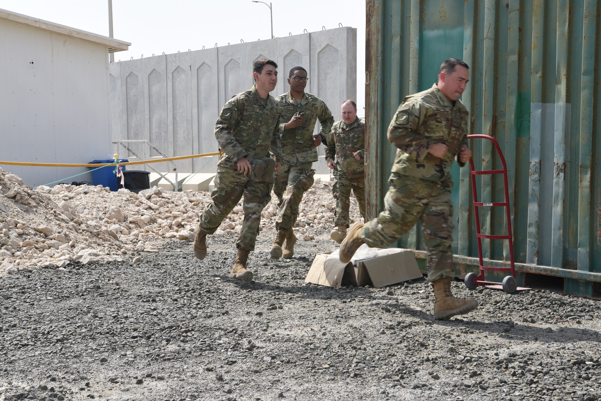 Members of the 380th Expeditionary Communications Squadron run to a bunker during an exercise May 28, 2019, on Al Dhafra Air Base, United Arab Emirates.