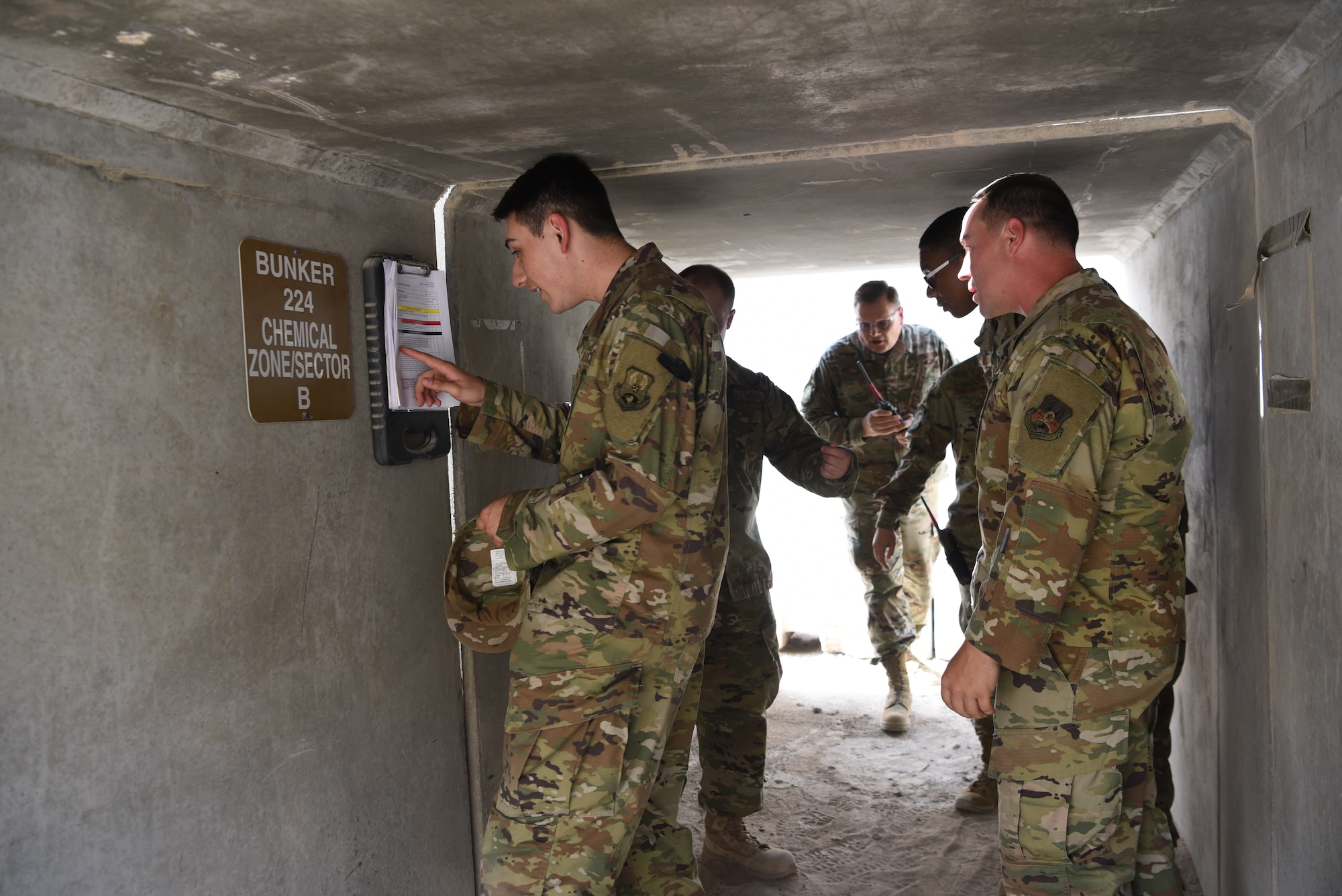 A member of the 380th Expeditionary Communications Squadron reviews a checklist inside of a bunker during an exercise May 28, 2019, on Al Dhafra Air Base, United Arab Emirates.