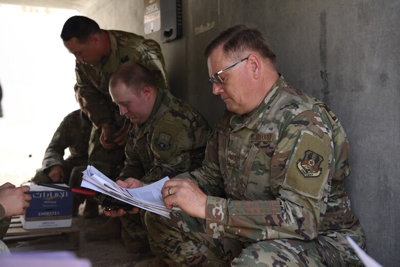 A member of the 380th Expeditionary Communications Squadron reviews a checklist inside of a bunker during an exercise May 28, 2019, on Al Dhafra Air Base, United Arab Emirates.