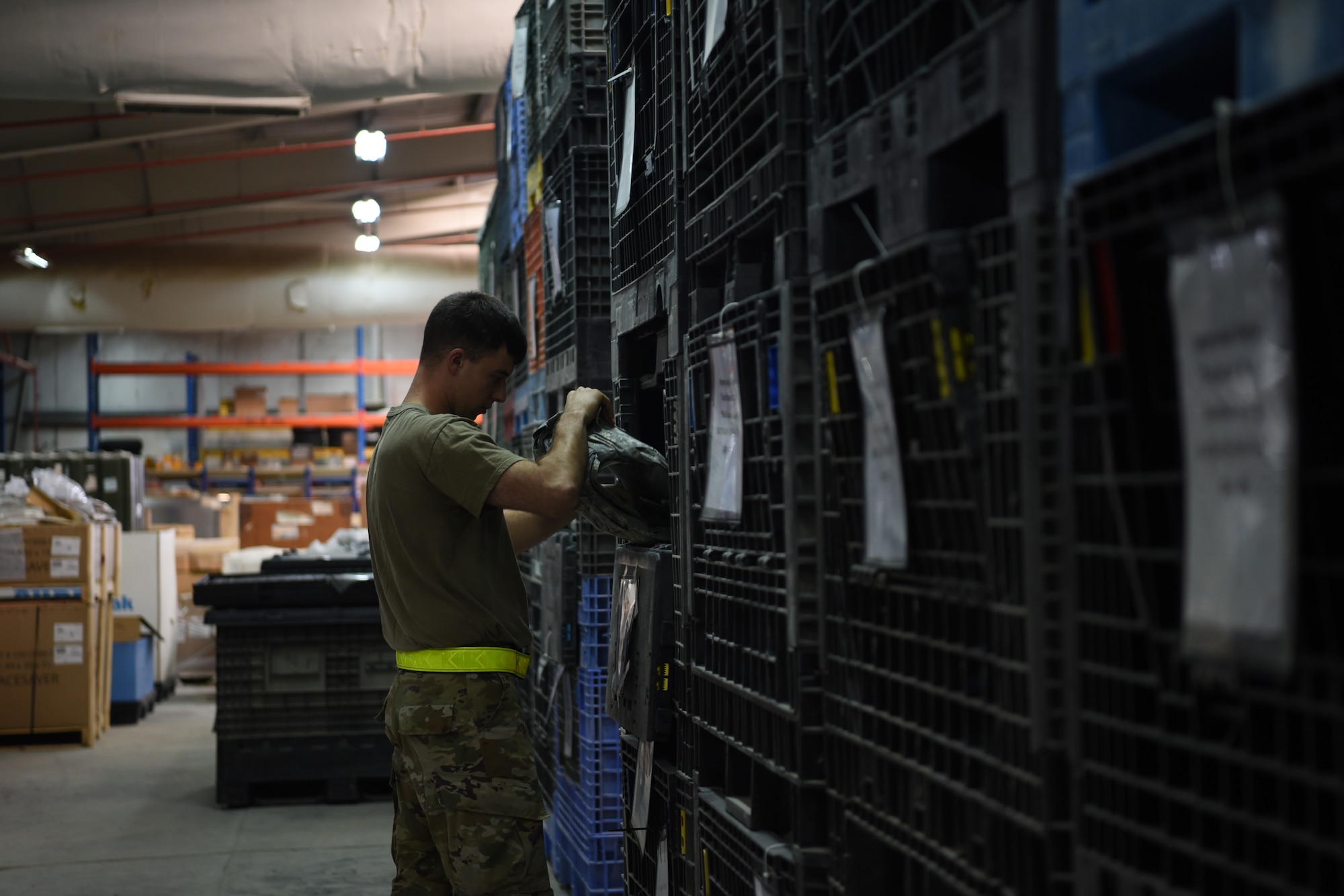 Senior Airman Logan Best, 380th Expeditionary Logistics Readiness Squadron vehicle maintenance, verifies the size of an Improved Outer Tactical Vest during an individual protective equipment issue exercise May 29, 2019, on Al Dhafra Air Base, United Arab Emirates.