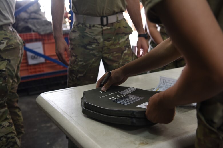 A members of the 380th Expeditionary Logistics Readiness Squadron verify serial numbers on body armor plates during an individual protective equipment issue exercise May 29, 2019, on Al Dhafra Air Base, United Arab Emirates.