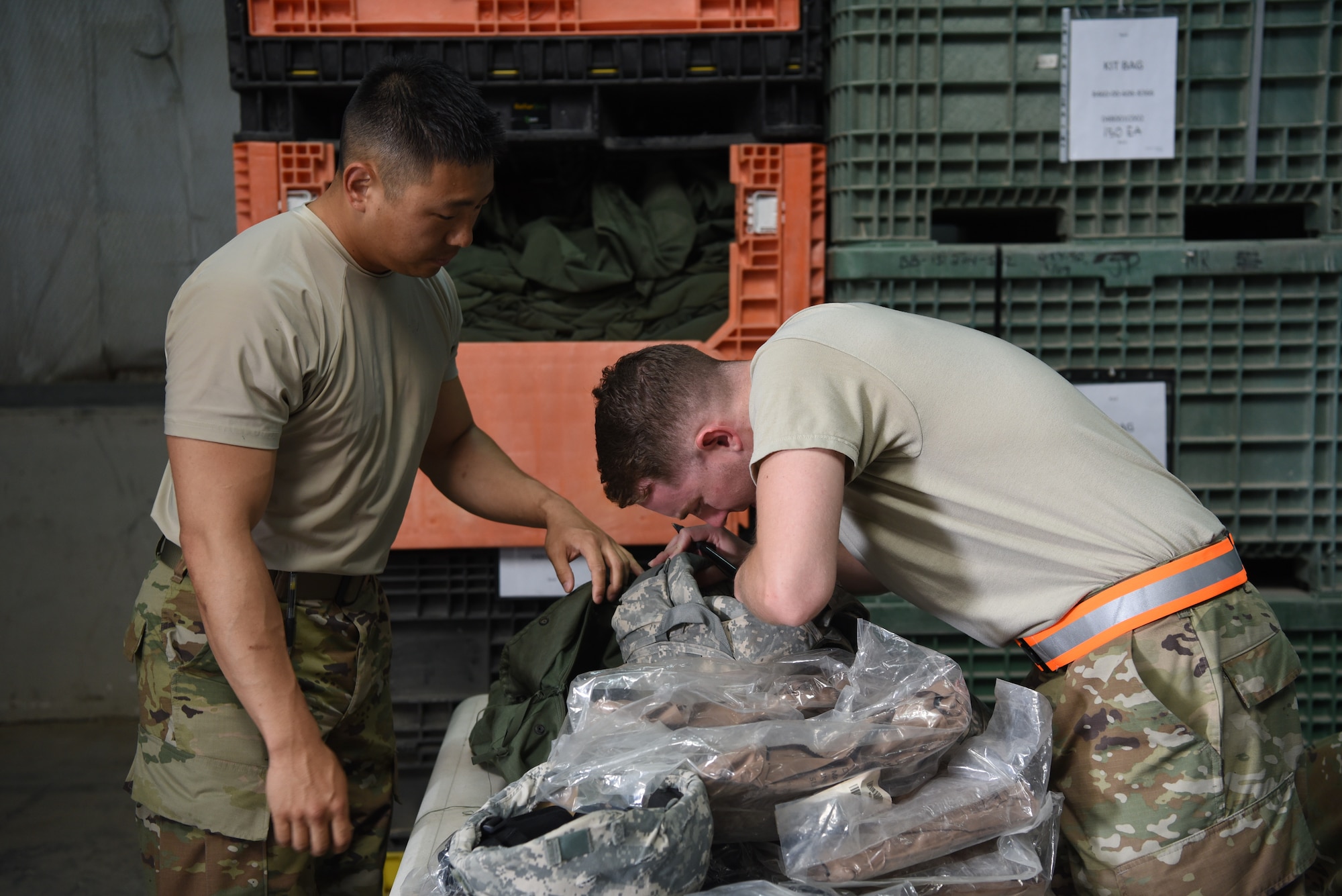 Airman 1st Class Christpoher Swartzentruber, 380th Expeditionary Logistics Readiness Squadron materiel management, confirms the size of an Improved Outer Tactical Vest during an individual protective equipment issue exercise May 29, 2019, on Al Dhafra Air Base, United Arab Emirates.