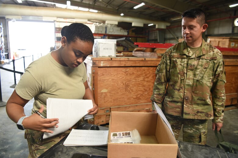 Staff Sgt. Desiree Bond, 380th Expeditionary Medical Group medical logistics technician, is the last stop in the line during an individual protective equipment issue exercise May 29, 2019, on Al Dhafra Air Base, United Arab Emirates.