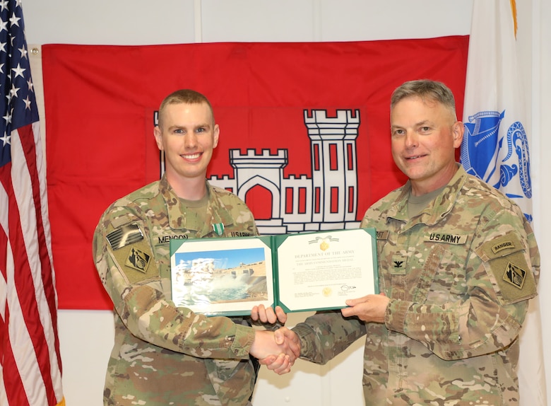 Capt. William Mengon (left) is presented with an Army Commendation Medal by Mosul Dam Task Force Commander Col. Phillip Secrist during a ceremony held in Mosul, Iraq on June 14, 2019. Mengon was assigned to MDTF where he advised the Iraqi Ministry of Water Resources on warehouse operations.