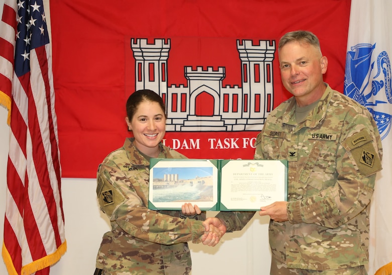 Capt. Laura Winn (left) is presented with an Army Commendation Medal by U.S. Army Corps of Engineers Mosul Dam Task Force Commander Col. Philip Secrist during a ceremony held in Mosul, Iraq on June 14, 2019. Winn served as a battle captain, requesting and monitoring air movements for the entire task force, maintaining accountability and force-protection procedures.Mosul Dam is a well-designed and well-constructed dam that is unique in that it requires continuous maintenance grouting operations due to the geology under the dam. USACE arrived at Mosul Dam in September 2016 to serve as “the Engineer” providing construction management, quality assurance, engineering and technical oversight and project management services in connection with a contract between Iraq and an Italian company for maintenance grouting and rehabilitation of the bottom outlet of the Mosul Dam.