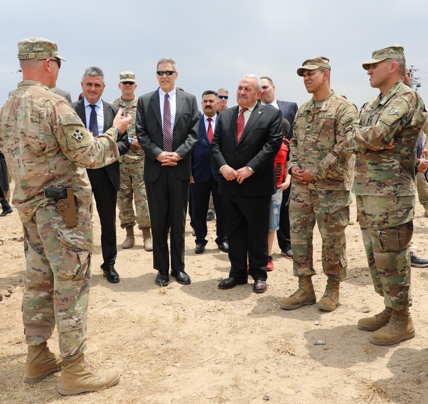 Mosul Dam Task Force Commander Col. Philip Secrist (left) speaks to Italian Ambassador to Iraq Bruno Pasquino, U.S. Ambassador to Iraq Matthew H. Tueller, Iraq Minister of Water Resources Jamal Abbas al-Adili, U.S. Army Corps of Engineers Transatlantic Division Commander Col. Mark Quander and TAD Command Sergeant Major Randolph Delapena during a tour of Mosul Dam. The dignitaries were visiting the MDTF on June 15, 2019, for a ceremony commemorating the completion the Mosul Dam Project, which started in 2016 as a joint project among the Iraq Ministry of Water Resources, the U.S. Army Corps of Engineers, and Italian Company Trevi S.p.A. in an effort to stabilize the infrastructure of the Mosul Dam. The Dam is the largest in Iraq and the fourth largest in the Middle East. It supplies water, hydropower, irrigation and flood control to the region.