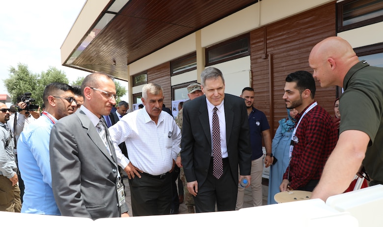 U.S. Ambassador to Iraq Matthew H. Tueller (center with tie) speaks to members of the Mosul Dam's Iraq workforce following a ceremony June 15, 2019, in Mosul, Iraq. The ambassador and other dignitaries were at the dam to commemorate the completion of the U.S. Army Corps of Engineers work supporting the Mosul Dam Project. The Mosul Dam Project started in 2016 as a joint project among the Iraq Ministry of Water Resources, USACE, and Italian Company Trevi S.p.A. in an effort to stabilize the infrastructure of the Mosul Dam. The Dam, which is the largest in Iraq, and the fourth largest in the Middle East, supplies water, hydropower, irrigation and flood control to the region. USACE's Mosul Dam Task Force acted as "The Engineer" for the joint endeavor.
