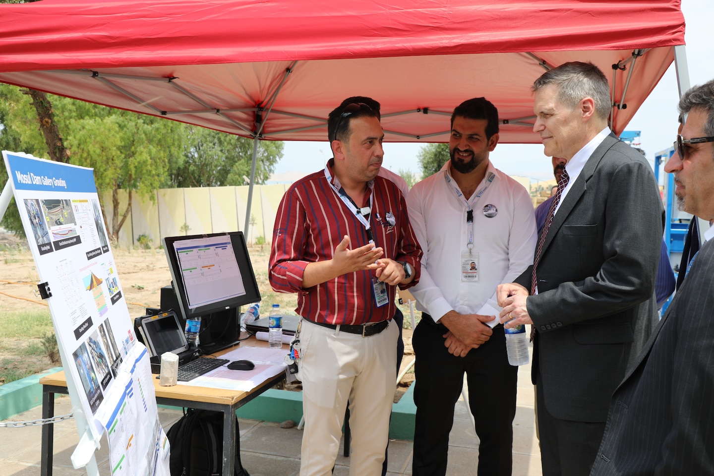 U.S. Ambassador to Iraq Matthew H. Tueller (center with tie) speaks to members of the Mosul Dam's Iraq workforce following a ceremony June 15, 2019, in Mosul, Iraq. The ambassador and other dignitaries were at the dam to commemorate the completion of the U.S. Army Corps of Engineers work supporting the Mosul Dam Project. The Mosul Dam Project started in 2016 as a joint project among the Iraq Ministry of Water Resources, USACE, and Italian Company Trevi S.p.A. in an effort to stabilize the infrastructure of the Mosul Dam. The Dam, which is the largest in Iraq, and the fourth largest in the Middle East, supplies water, hydropower, irrigation and flood control to the region. USACE's Mosul Dam Task Force acted as "The Engineer" for the joint endeavor.