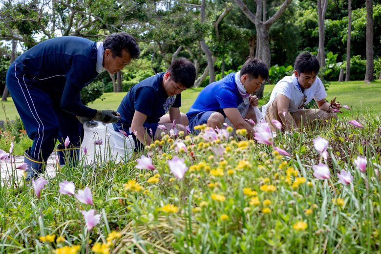 Japan Self-Defense Force service members pick leaves out of a flower bed during a cleanup June 15 at Peace Memorial Park, Okinawa, Japan. The cleanup was done in preparation for Okinawa Memorial day, June 23, where many families come to Peace Memorial Park to honor the fallen soldiers from the Battle of Okinawa. (U.S. Marine Corps photo by Lance Cpl. Nicole Rogge)