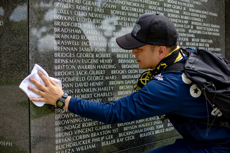 Fuchiue Kensaku, a volunteer, wipes a memorial wall during a cleanup June 15 at Peace Memorial Park, Okinawa, Japan. The cleanup was done in preparation for Okinawa Memorial day, June 23, where many families come to Peace Memorial Park to honor the fallen soldiers from the Battle of Okinawa. (U.S. Marine Corps photo by Lance Cpl. Nicole Rogge)