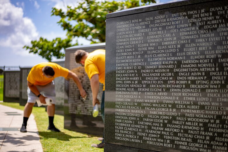 U.S. Service members clean a memorial wall during a cleanup June 15 at Peace Memorial Park, Okinawa, Japan. The cleanup was done in preparation for Okinawa Memorial day, June 23, where many families come to Peace Memorial Park to honor the fallen soldiers from the Battle of Okinawa. (U.S. Marine Corps photo by Lance Cpl. Nicole Rogge)