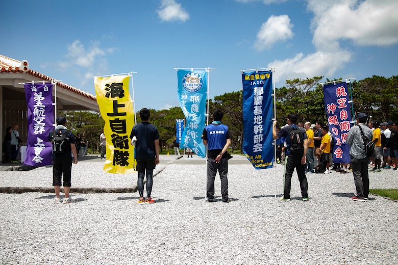 Members of the Japan Self-Defense Force flank the walkway to a shrine after participating in a cleanup June 15 at Peace Memorial Park, Okinawa, Japan. The cleanup was done in preparation for Okinawa Memorial day, June 23, where many families come to Peace Memorial Park to honor the fallen soldiers from the Battle of Okinawa. (U.S. Marine Corps photo by Pfc. Jacob Foster)
