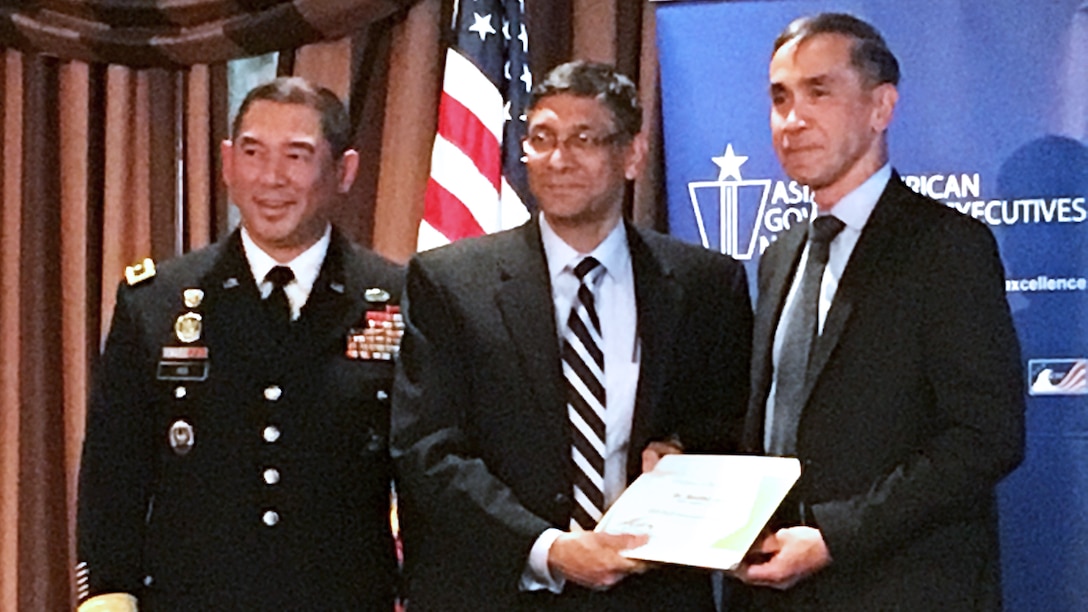Senthil Arul (center), program manager for DLA Information Operations Research and Development, receives the Innovative Leaders in Defense Award from Army Maj. Gen. Garrett S. Yee (right) and Arsenio “Bong” Gumahad at the Asian-American Government Executives Network 2019 Leadership Workshop June 6 in Crystal City, Virginia.