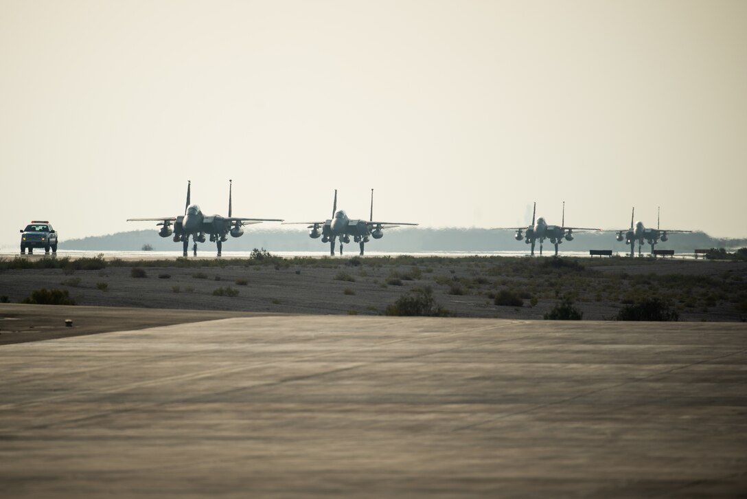 Four F-15E Strike Eagles from the 336th Fighter Squadron, 4th Fighter Wing at Seymour Johnson Air Force Base, North Carolina taxi the runway at Al Dhafra Air Base, United Arab Emirates, June 13, 2019. The F-15E’s joined ADABs inventory of other fighters to include F-15C Eagles and F-35A Lightning IIs. (U.S. Air Force photo by Staff Sgt. Chris Thornbury)