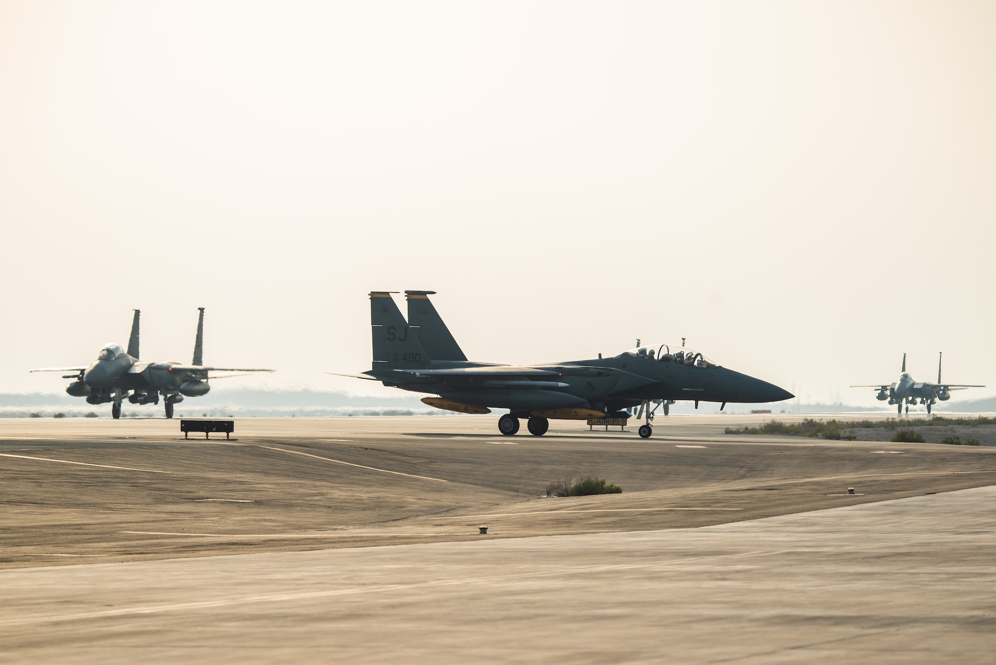 Three F-15E Strike Eagles from the 336th Fighter Squadron, 4th Fighter Wing at Seymour Johnson Air Force Base, North Carolina, taxi the runway at Al Dhafra Air Base, United Arab Emirates, June 13, 2019. The F-15E’s joined ADABs inventory of other fighters to include F-15C Eagles and F-35A Lightning IIs. (U.S. Air Force photo by Staff Sgt. Chris Thornbury)