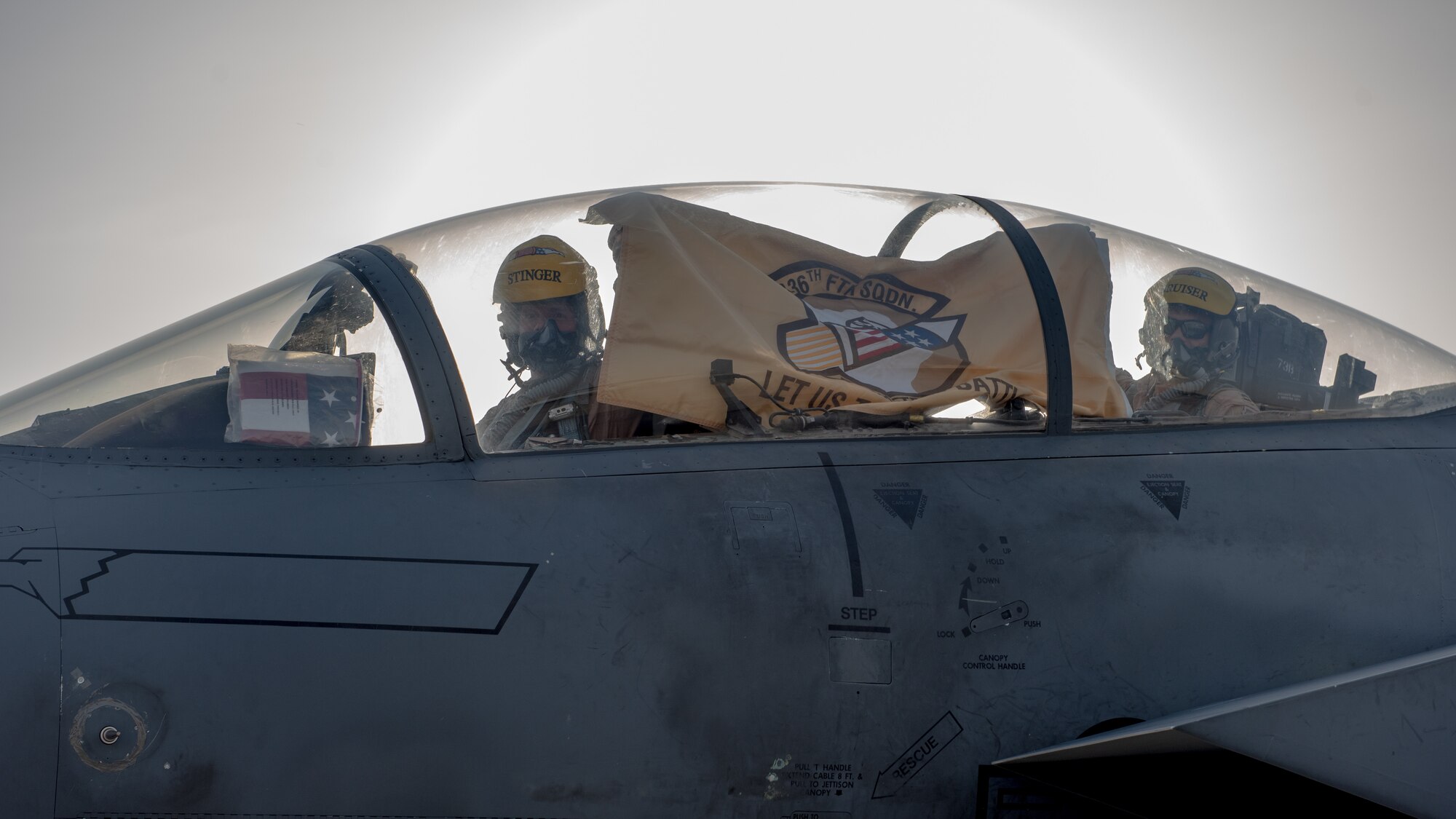 F-15E Strike Eagle aircrew hold up their 336th Fighter Squadron flag, June 13, 2019, at Al Dhafra Air Base, United Arab Emirates. The 336th FS deployed from the 4th Fighter Wing at Seymour Johnson AFB, North Carolina, bringing additional air power to Team ADAB. (U.S. Air Force photo by Staff Sgt. Chris Thornbury)