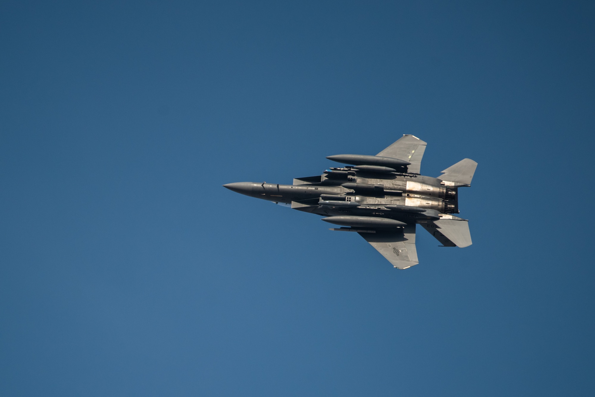 An F-15E Strike Eagle from the 336th Fighter Squadron, 4th Fighter Wing at Seymour Johnson Air Force Base, North Carolina peels away from a three-ship formation at Al Dhafra Air Base, United Arab Emirates, June 14, 2019. The F-15E’s joined ADABs inventory of other fighters to include F-15C Eagles and F-35A Lightning IIs. (U.S. Air Force photo by Staff Sgt. Chris Thornbury)