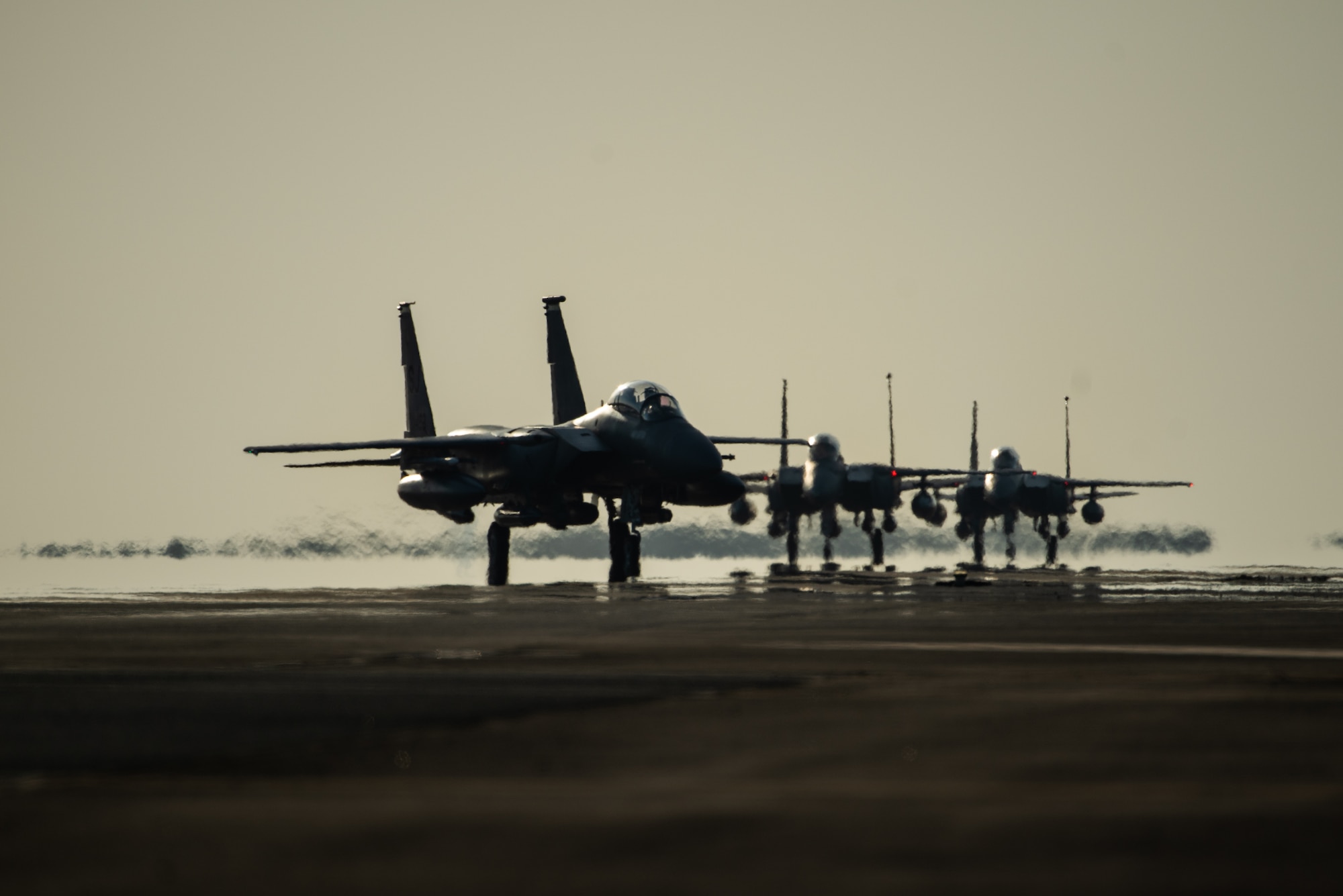 Three F-15E Strike Eagles from the 336th Fighter Squadron, 4th Fighter Wing at Seymour Johnson Air Force Base, North Carolina taxi the runway at Al Dhafra Air Base, United Arab Emirates, June 14, 2019. The F-15E’s joined ADABs inventory of other fighters to include F-15C Eagles and F-35A Lightning IIs. (U.S. Air Force photo by Staff Sgt. Chris Thornbury)