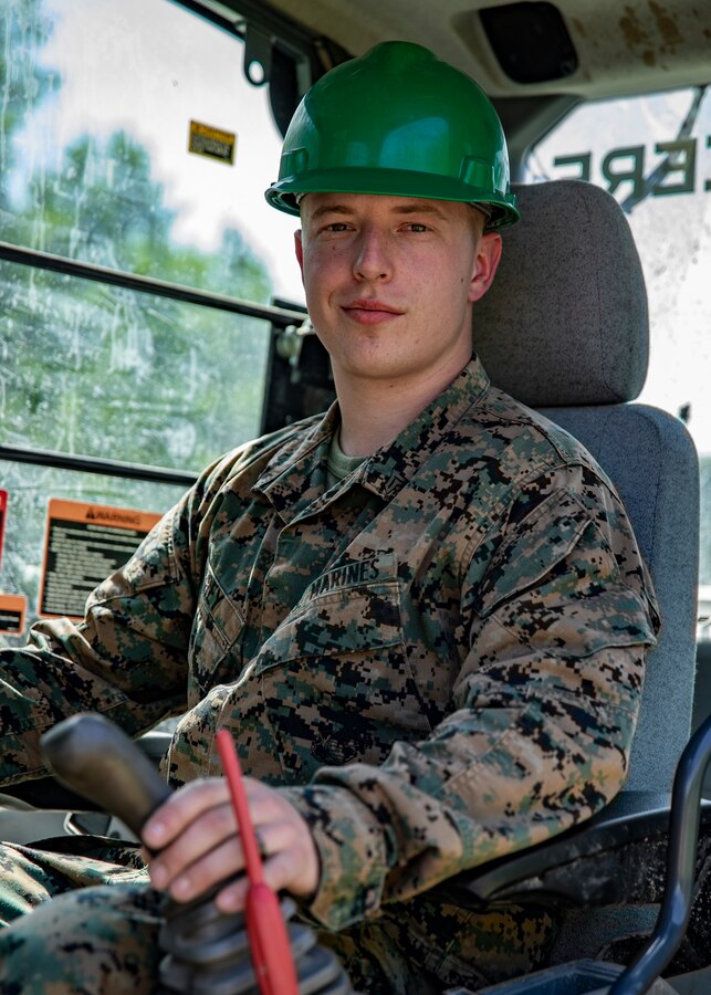 U.S. Marine Corps Cpl. Dakota R. Frey, a heavy equipment operator with Marine Wing Support Squadron 471, Marine Aircraft Group 41, 4th Marine Aircraft Wing, operates a hydraulic excavator at Canadian Forces Base Cold Lake, Canada, June 12, 2019, in preparation of Sentinel Edge 19. Reserve Marines with MAG-41 worked together to rebuild a road in order to build community relations, maintain job proficiency and ensure deployment readiness. (U.S. Marine Corps photo by Lance Cpl. Jose Gonzalez)