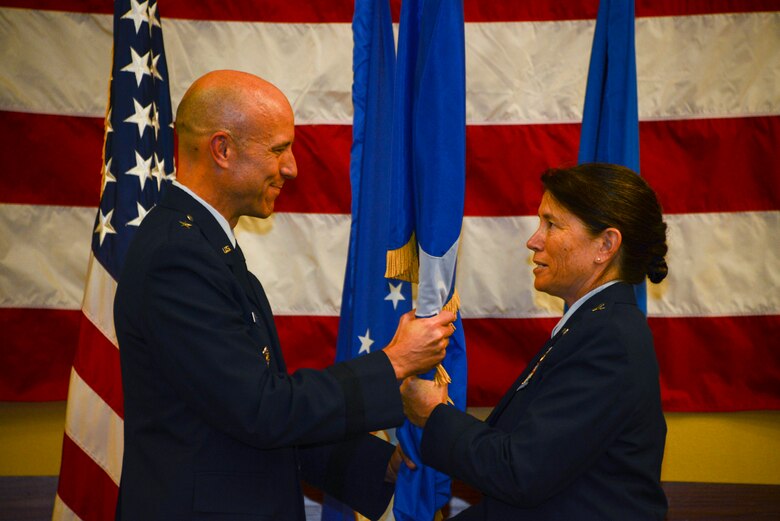 Two people holding a flag.