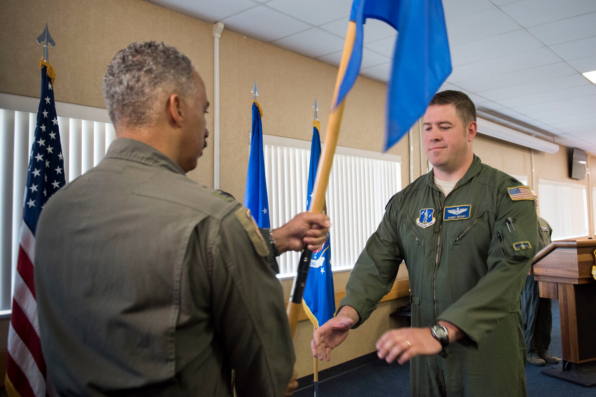 167th Airlift Wing Commander, Col. David Cochran, hands a guidon to Lt. Col. Randy Wright marking Wright’s assumption of command of the 167th Airlift Squadron during a ceremony in the 167th Airlift Wing’s dining facility, June 6, 2019. (U.S. Air National Guard photo by Senior Master Sgt. Emily Beightol-Deyerle)