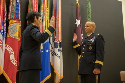 Maj. Gen. Barbara Holcomb administers the oath of office to Brig. Gen. Jack Davis during his promotion ceremony in Medical Education and Training Campus’ Anderson Hall Auditorium at Joint Base San Antonio-Fort Sam Houston June 7.