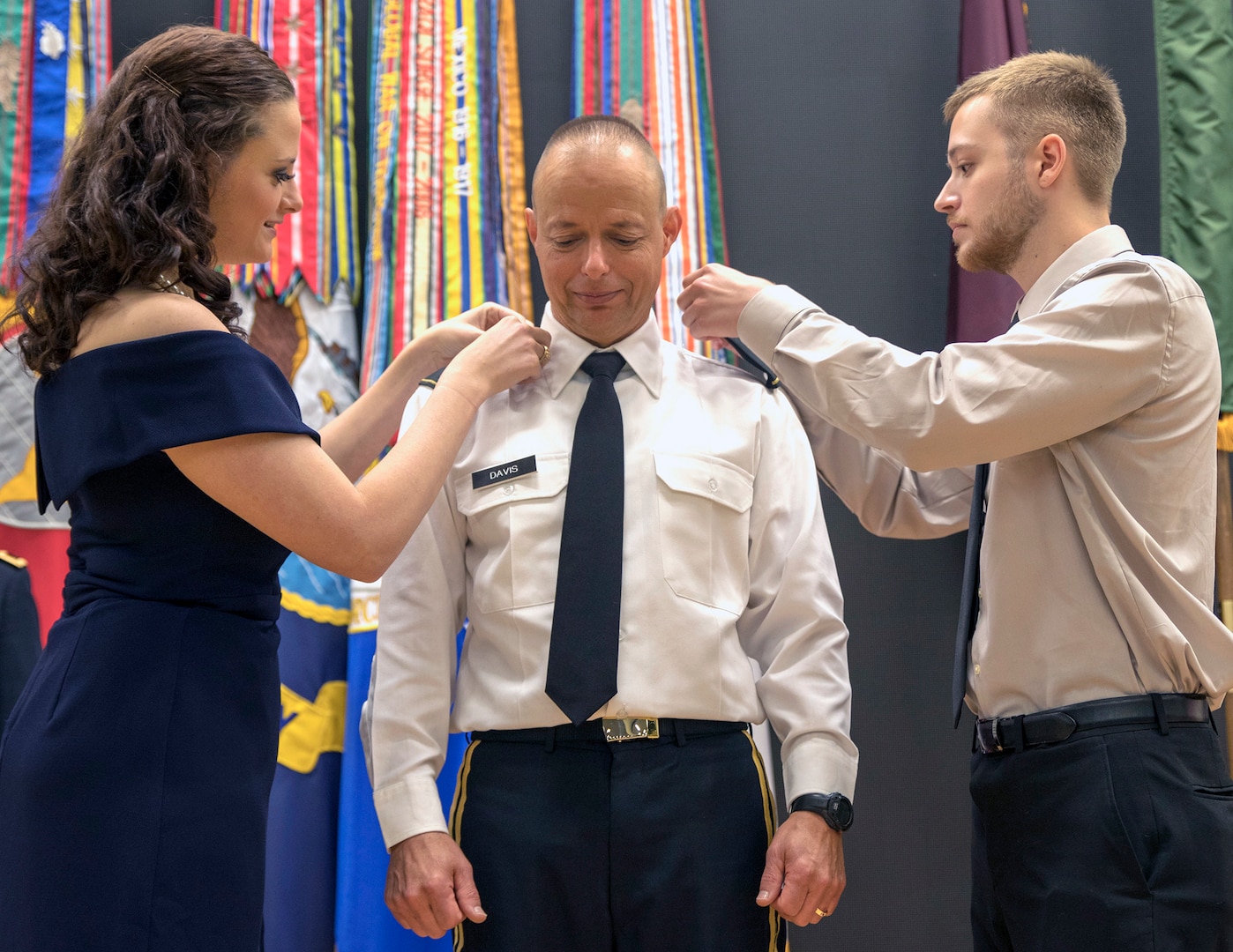 Brig. Gen. Jack Davis' children, Katie and Jacob, place his new rank on his dress shirt during his promotion ceremony in METC’s Anderson Hall Auditorium at Joint Base San Antonio-Fort Sam Houston June 7.